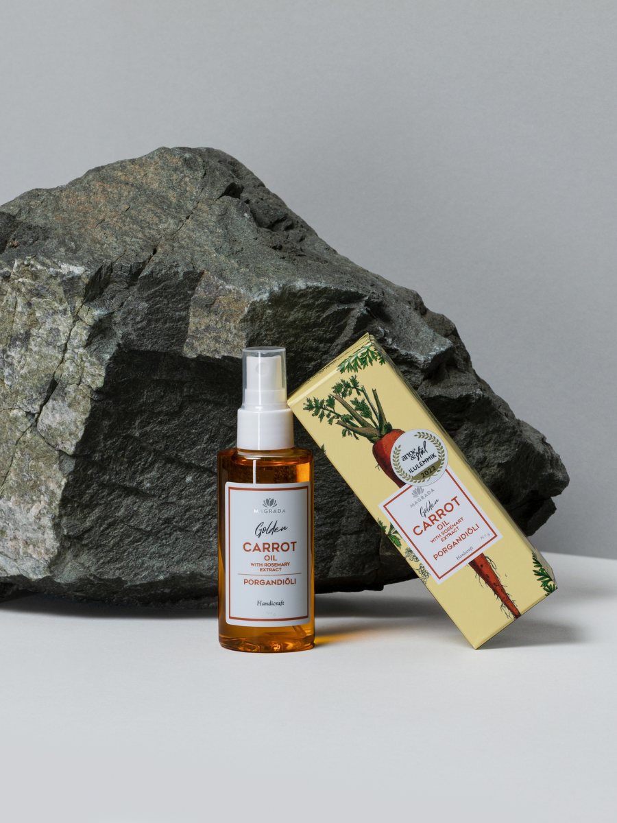 Magrada Golden Carrot Oil mit Verpackung auf Naturstein – Karottenöl mit Rosmarinextrakt